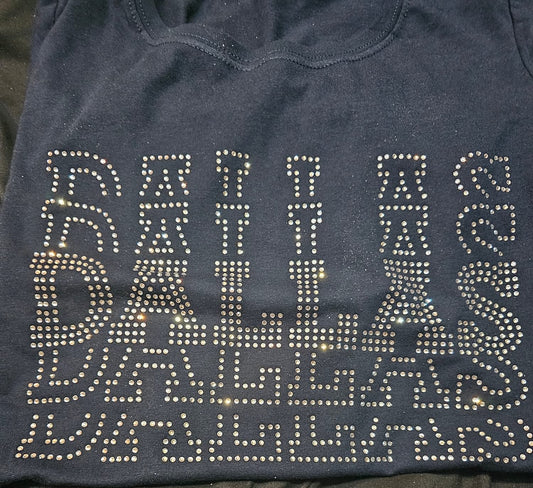 Black shirt with 'DALLAS' text in rhinestones on a dark background